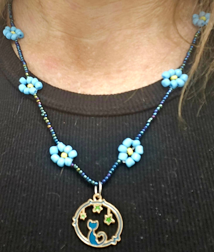 Rope style blue daisy chain featuring a Cat Moon pendant