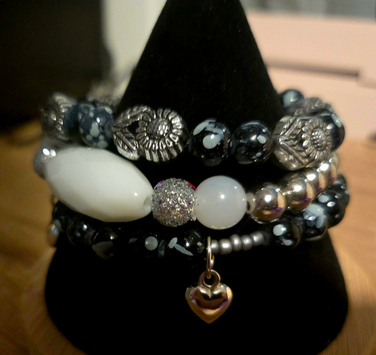 Black beaded 3 bracelet set with silver flowers beads and silver heart charms