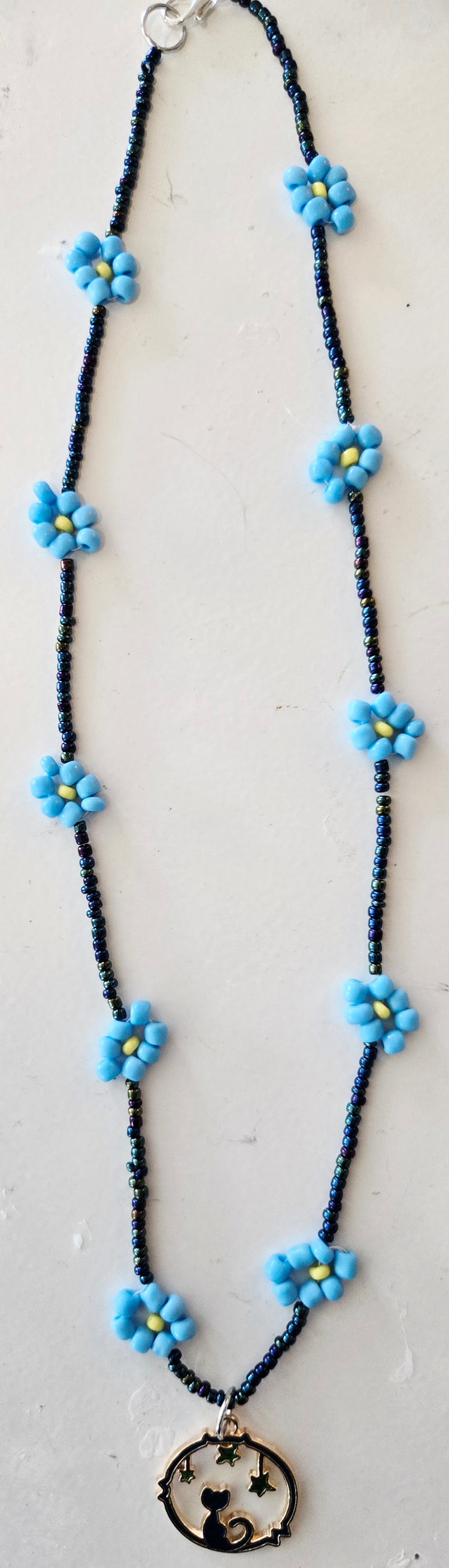 Rope style blue daisy chain featuring a Cat Moon pendant