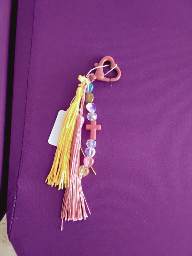 Yellow and pink cross keychain with tassels