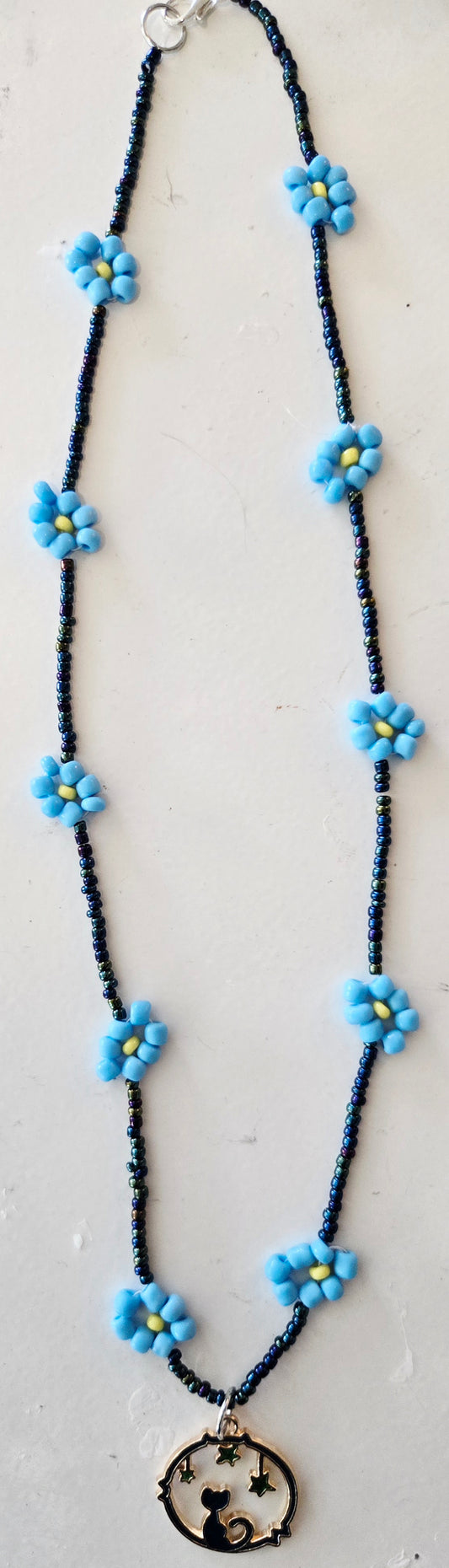 Rope style blue daisy chain featuring a Cat Moon pendant