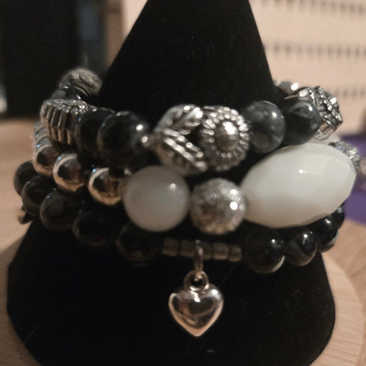 Black beaded 3 bracelet set with silver flowers beads and silver heart charms