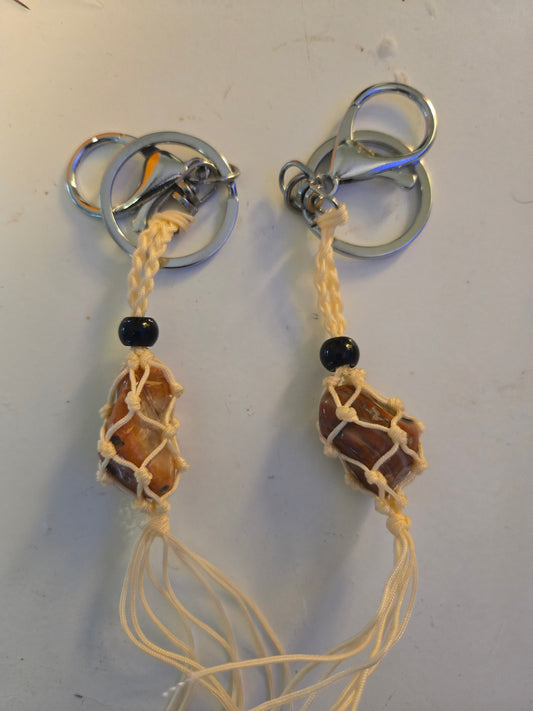 Cream colored macrame stone holders with small orange jasper stone