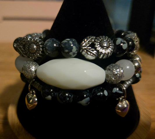 Black beaded 3 bracelet set with silver flowers beads and silver heart charms