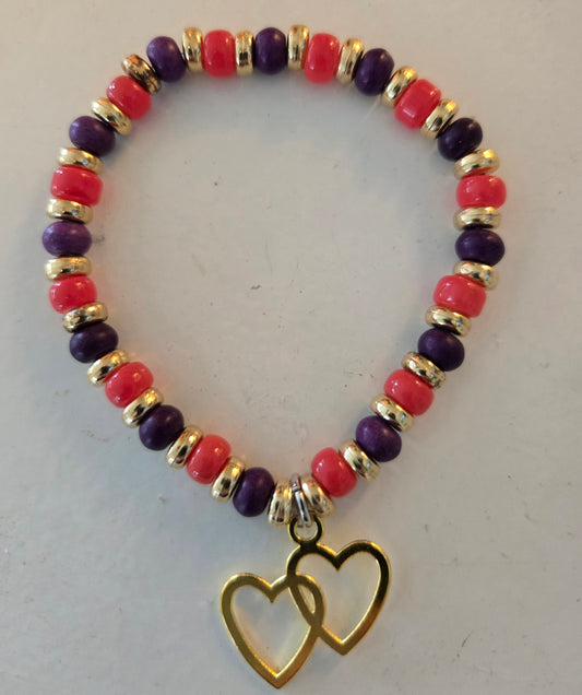Orange gold and purple beaded bracelet with gold double heart pendant